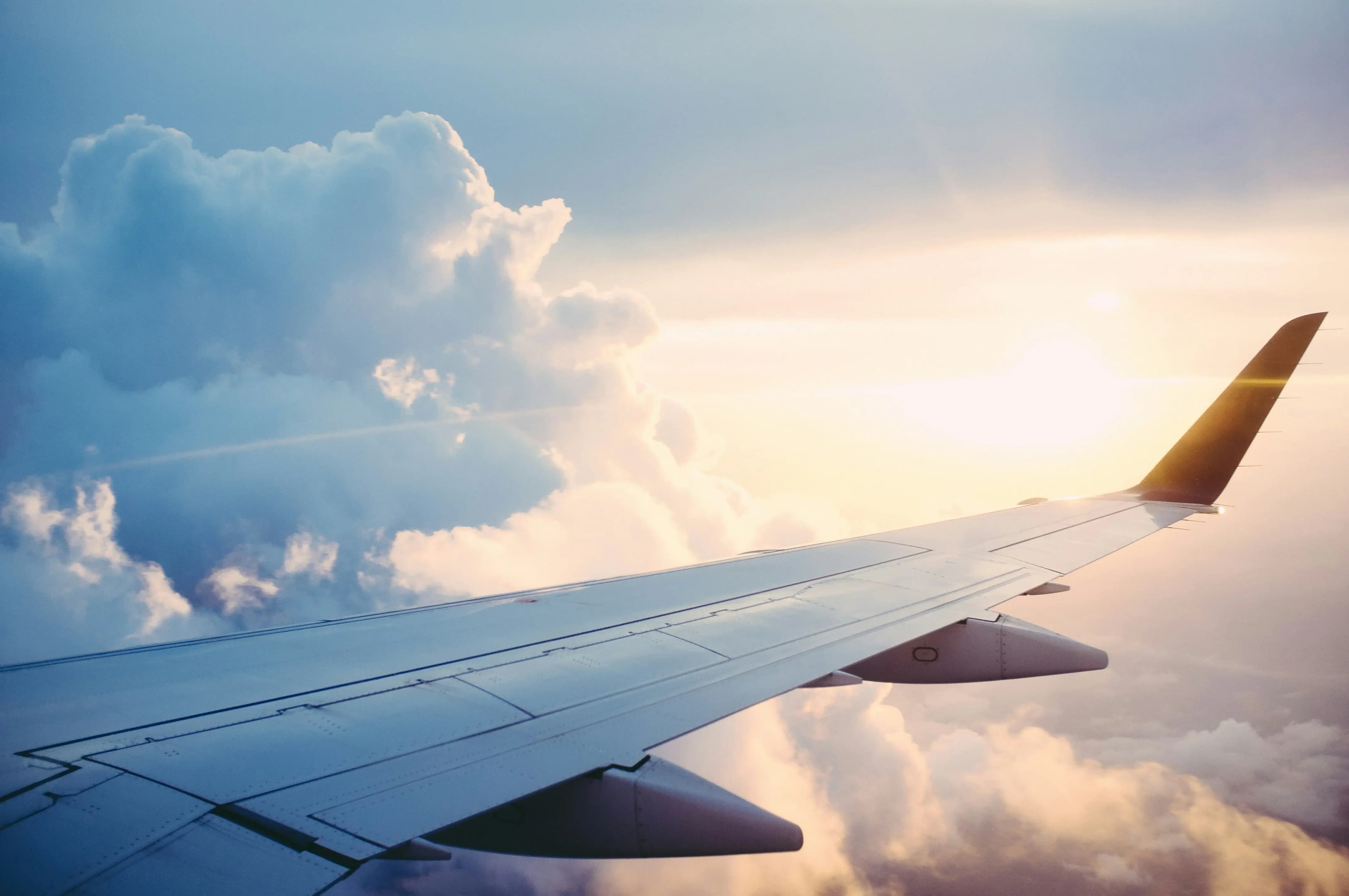 Aircraft wingtip above clouds — Turbcast turbulence forecast hero image